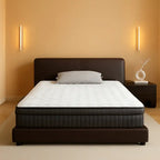 Modern bedroom with a dark upholstered platform bed, mattress, and minimalist decor
